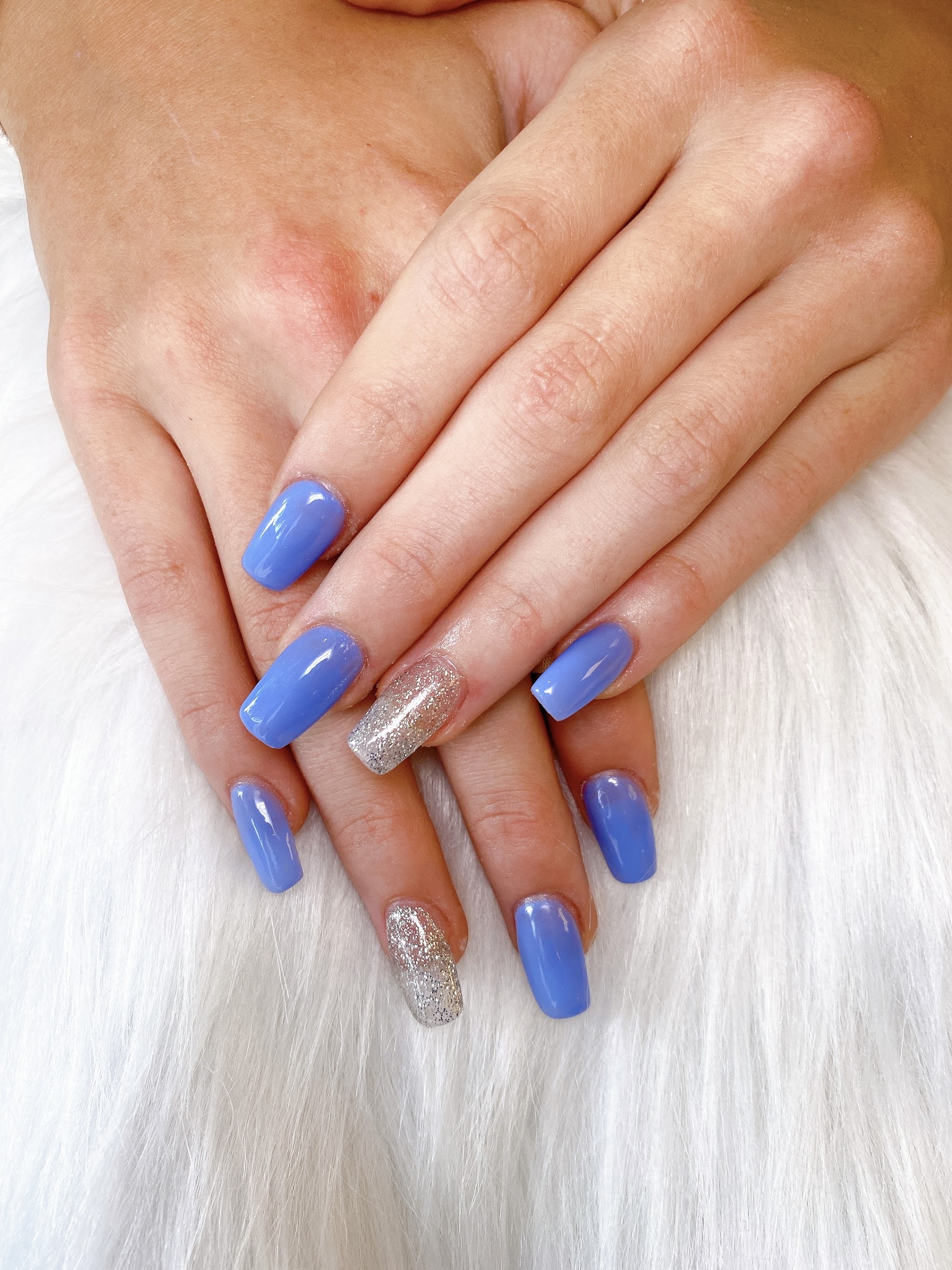 Nagels in lila-blauwe gellak met twee zilveren glitternagels